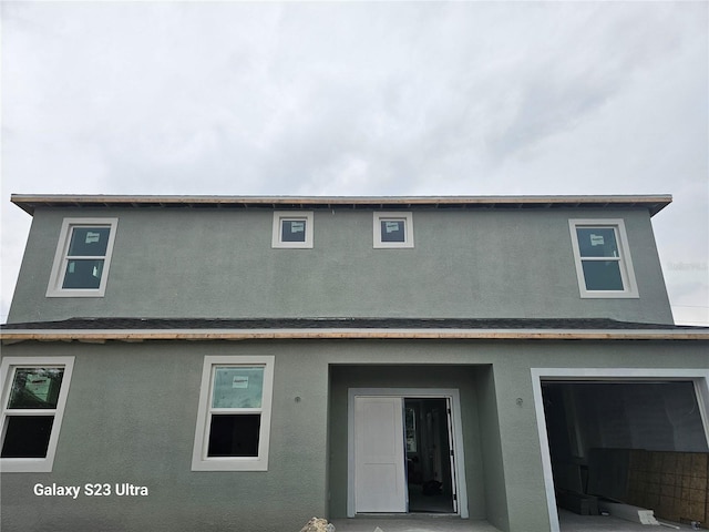 back of house featuring stucco siding