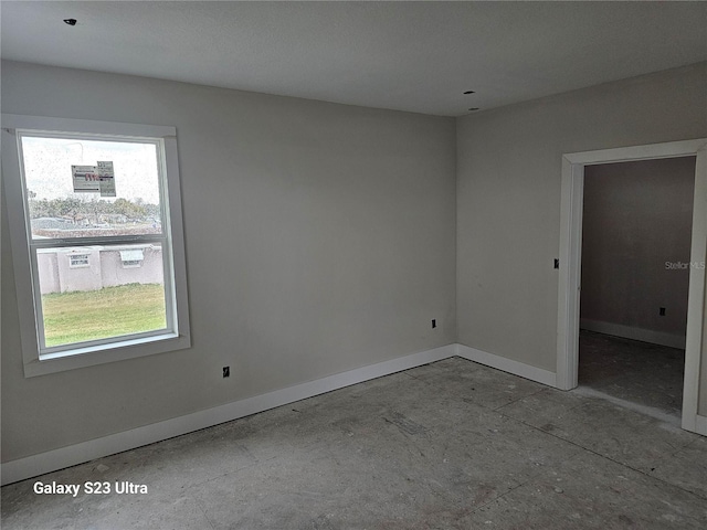 unfurnished room with a healthy amount of sunlight and baseboards