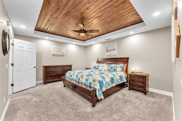 bedroom featuring ceiling fan, a raised ceiling, light carpet, and wooden ceiling