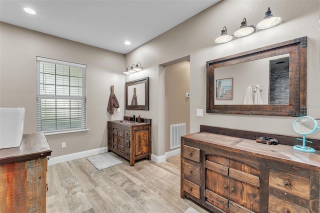 bathroom featuring hardwood / wood-style flooring and vanity