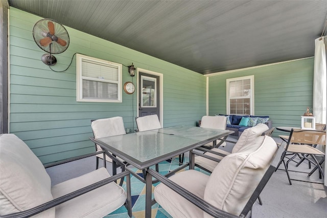 view of patio / terrace with ceiling fan and an outdoor living space