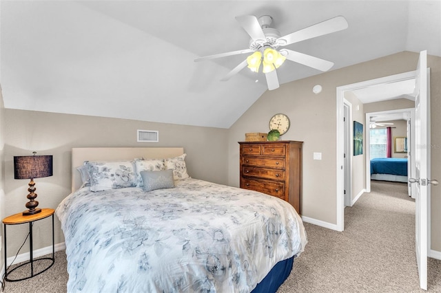 carpeted bedroom with vaulted ceiling and ceiling fan