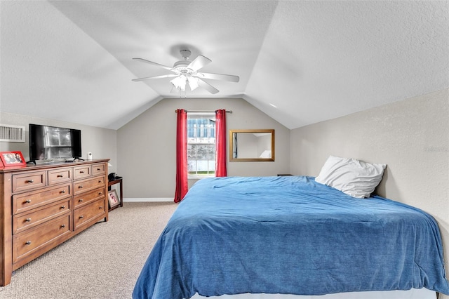 bedroom featuring ceiling fan, lofted ceiling, light colored carpet, and a textured ceiling