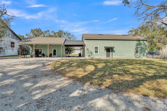 back of property with a lawn