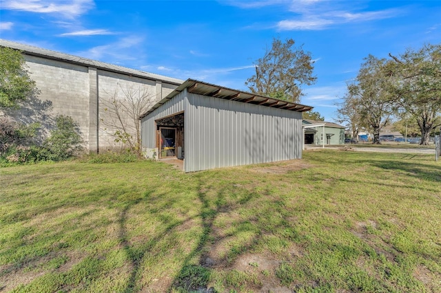 view of property exterior with a lawn and an outdoor structure