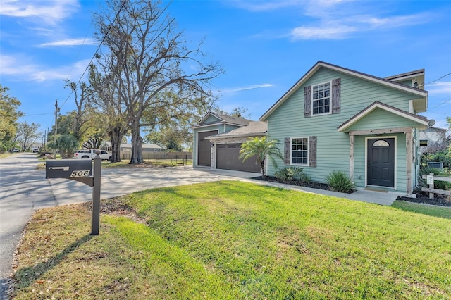 view of front of home with a garage and a front lawn