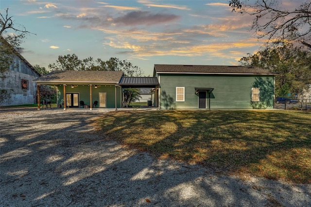 back house at dusk with a yard