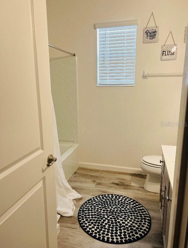 full bathroom featuring vanity, toilet, shower / bath combination, and hardwood / wood-style floors