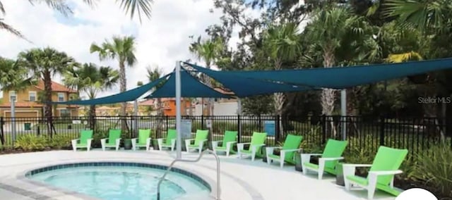 view of swimming pool featuring a hot tub and a patio area