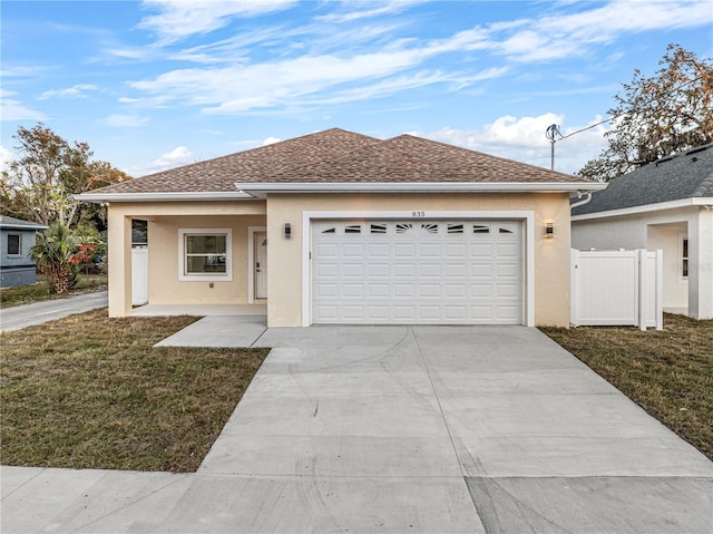 view of front of property with a garage and a front lawn