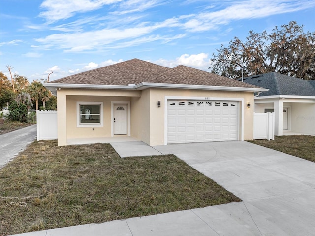 view of front of home featuring a garage and a front yard