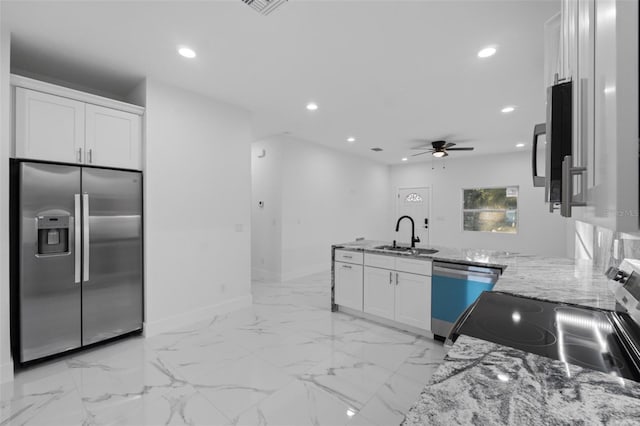 kitchen featuring sink, white cabinets, ceiling fan, light stone counters, and stainless steel appliances