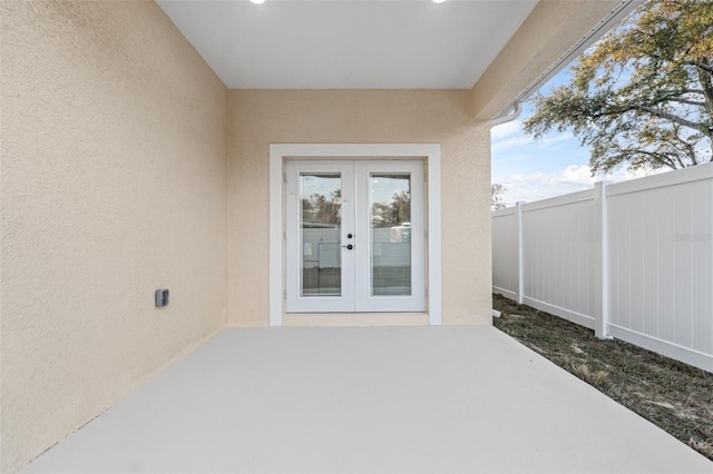 property entrance with a patio area and french doors