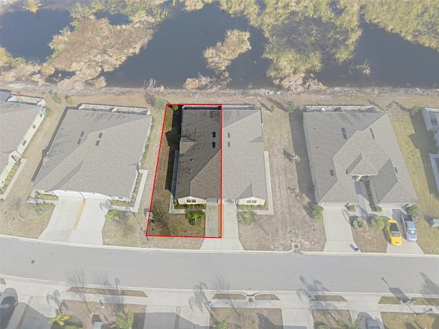 birds eye view of property featuring a water view