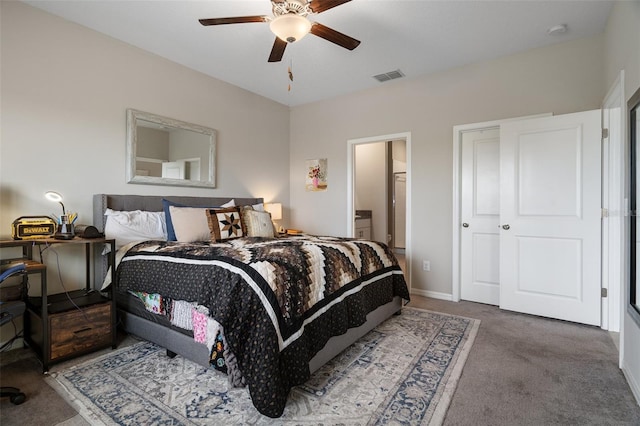 bedroom featuring carpet, ceiling fan, and ensuite bath