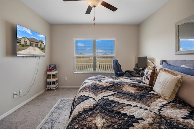 carpeted bedroom featuring ceiling fan and multiple windows