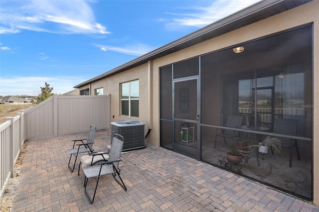 view of patio featuring a sunroom and central air condition unit