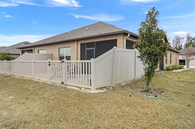 view of side of property featuring a yard