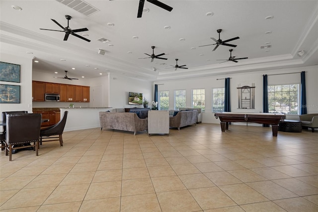 tiled living room with billiards, ornamental molding, and a tray ceiling