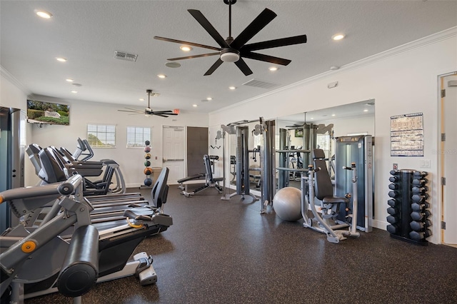 gym featuring ceiling fan, ornamental molding, and a textured ceiling