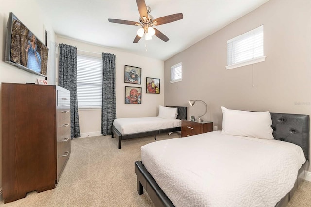 bedroom featuring light colored carpet and ceiling fan