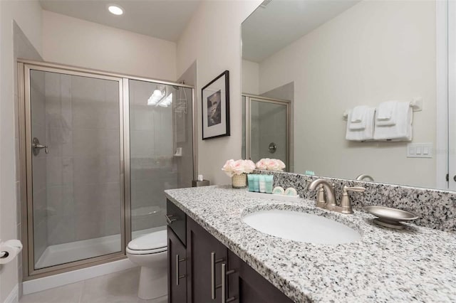 bathroom with walk in shower, tile patterned floors, vanity, and toilet