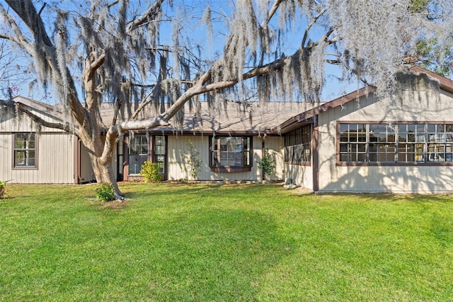 rear view of property featuring a yard