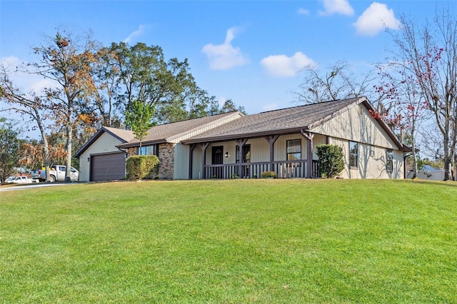 view of front of property with a garage, a front yard, and a porch