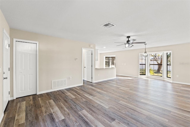 unfurnished living room featuring ceiling fan and hardwood / wood-style floors