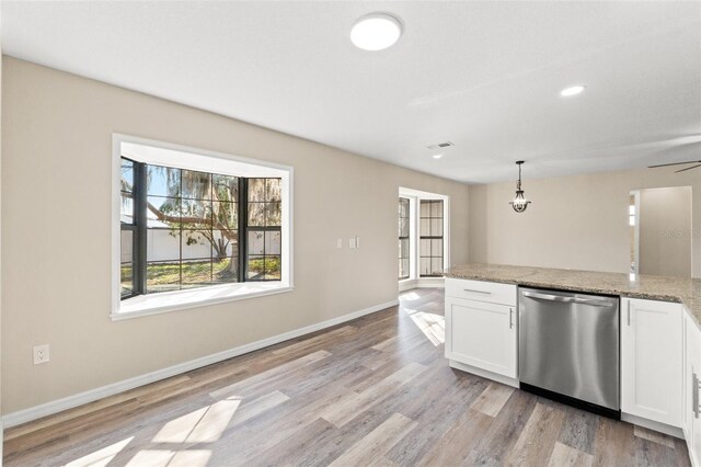 kitchen featuring white cabinets, light stone countertops, hanging light fixtures, and dishwasher