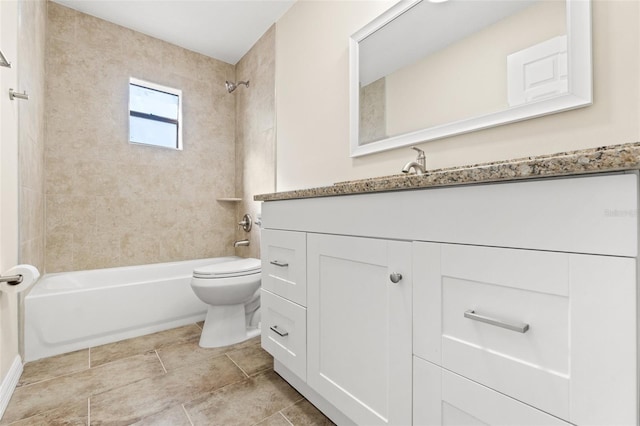 full bathroom featuring tiled shower / bath combo, vanity, and toilet