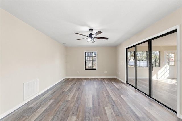 empty room with ceiling fan and light wood-type flooring