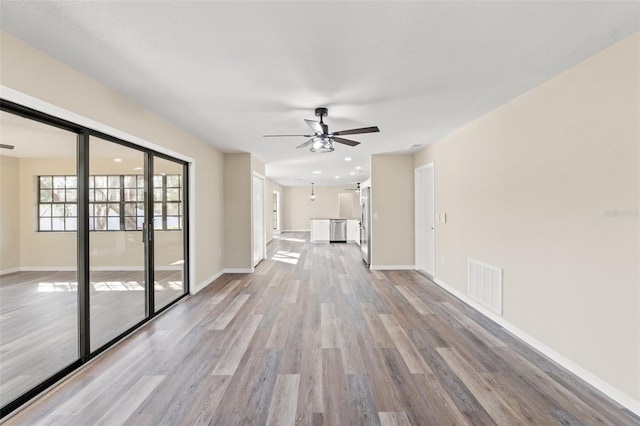 unfurnished living room featuring ceiling fan and light wood-type flooring