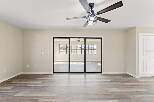 spare room with ceiling fan and light wood-type flooring