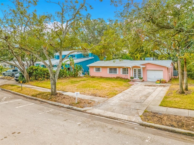 single story home featuring a garage and a front yard