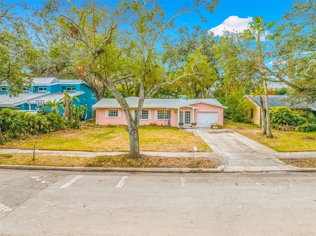 view of front of house with a garage and a front yard