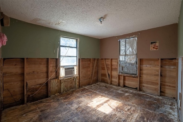 unfurnished room featuring cooling unit and a textured ceiling