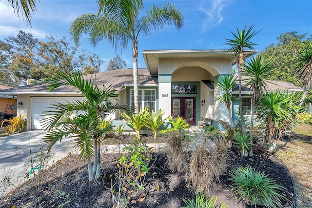 view of front of home with french doors and a garage