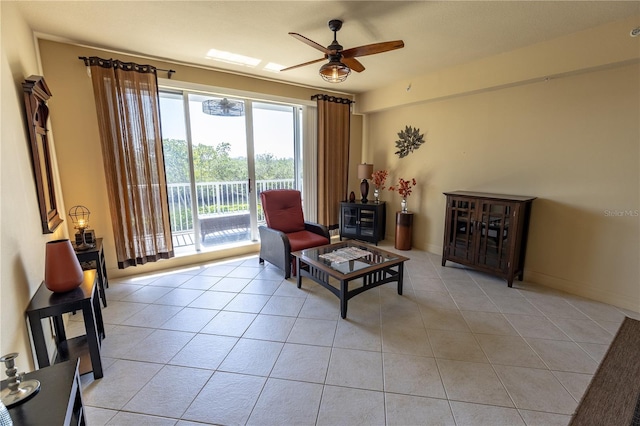 living area featuring light tile patterned floors and ceiling fan