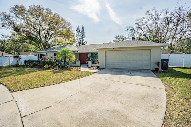 ranch-style home featuring a garage and a front lawn