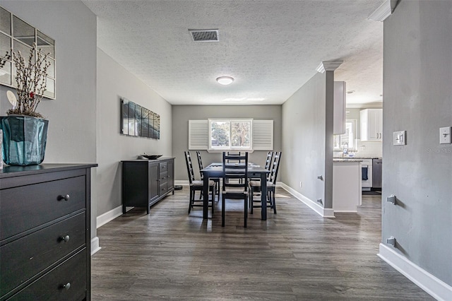 dining area featuring dark hardwood / wood-style floors and a textured ceiling