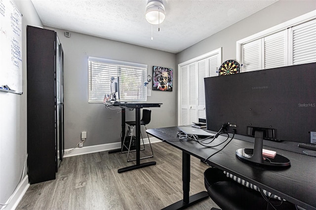 home office featuring hardwood / wood-style flooring and a textured ceiling