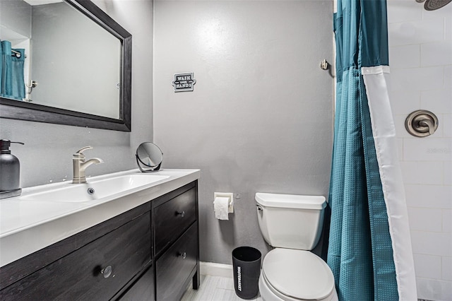 bathroom with vanity, walk in shower, and toilet