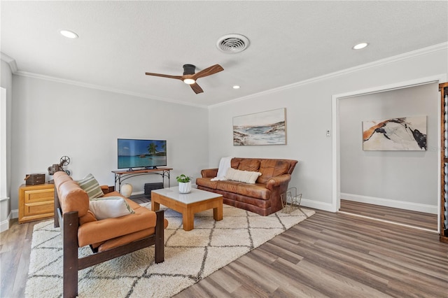 living room featuring hardwood / wood-style floors, crown molding, a textured ceiling, and ceiling fan