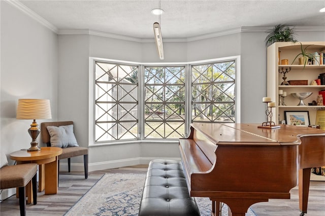 interior space featuring crown molding, a healthy amount of sunlight, hardwood / wood-style floors, and a textured ceiling