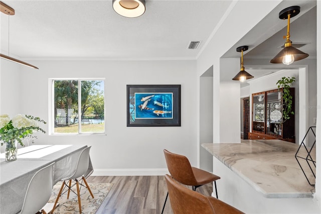 interior space with hardwood / wood-style flooring and ornamental molding