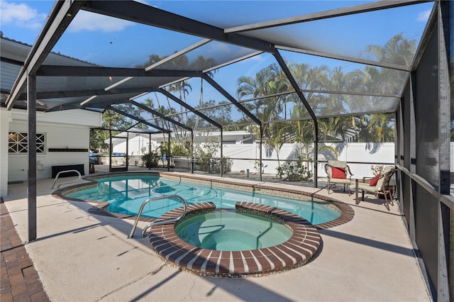 view of swimming pool featuring an in ground hot tub, a lanai, and a patio area