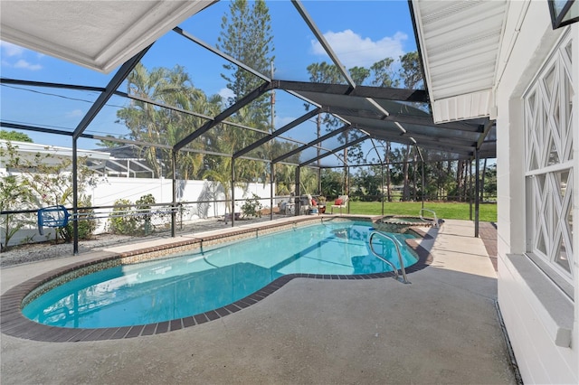 view of swimming pool featuring a patio, a lanai, and an in ground hot tub