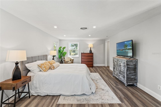 bedroom featuring dark wood-type flooring and a textured ceiling