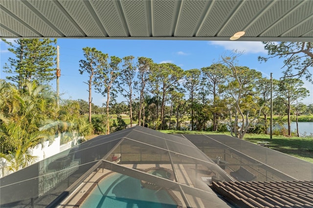 view of pool featuring a water view and glass enclosure